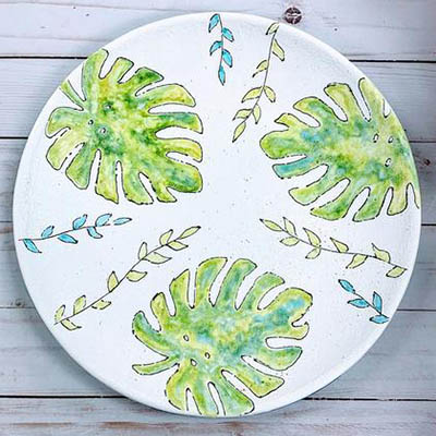 A plate with green leaves on it