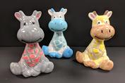 Three ceramic animals are sitting on a table.