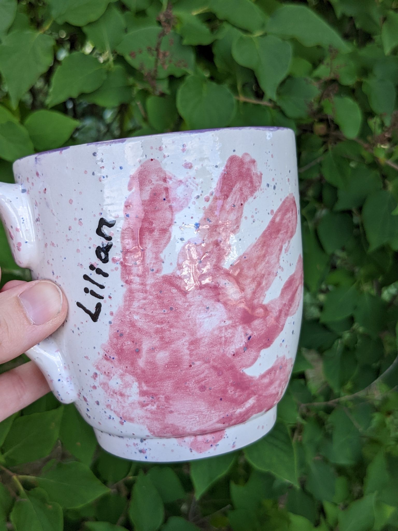 A hand print mug with the name lilian on it.