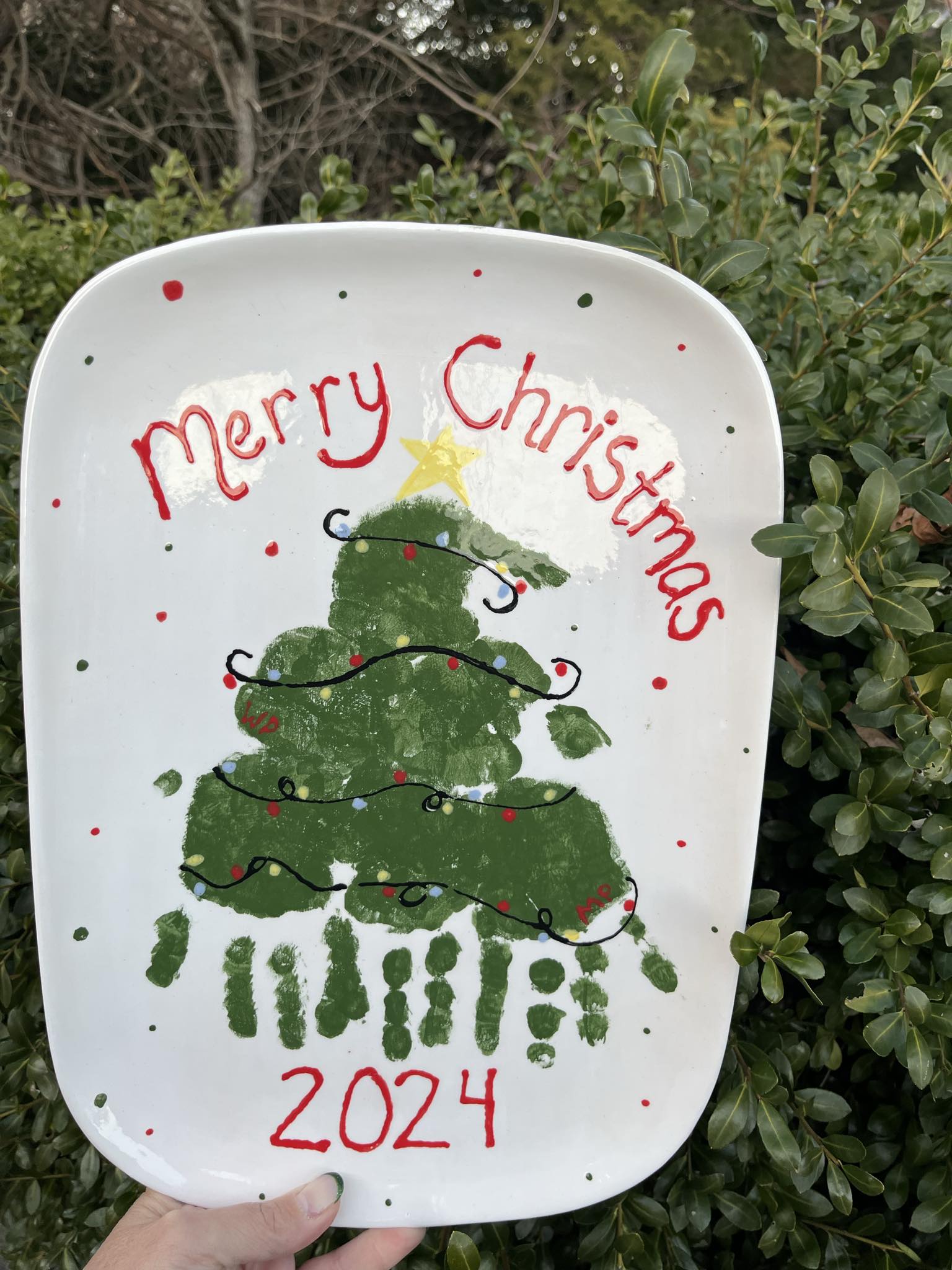 A plate with handprint christmas tree on it.